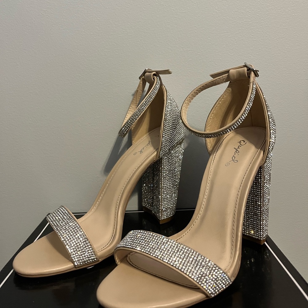 Step out and sparkle block heels in the color nude and size 6.